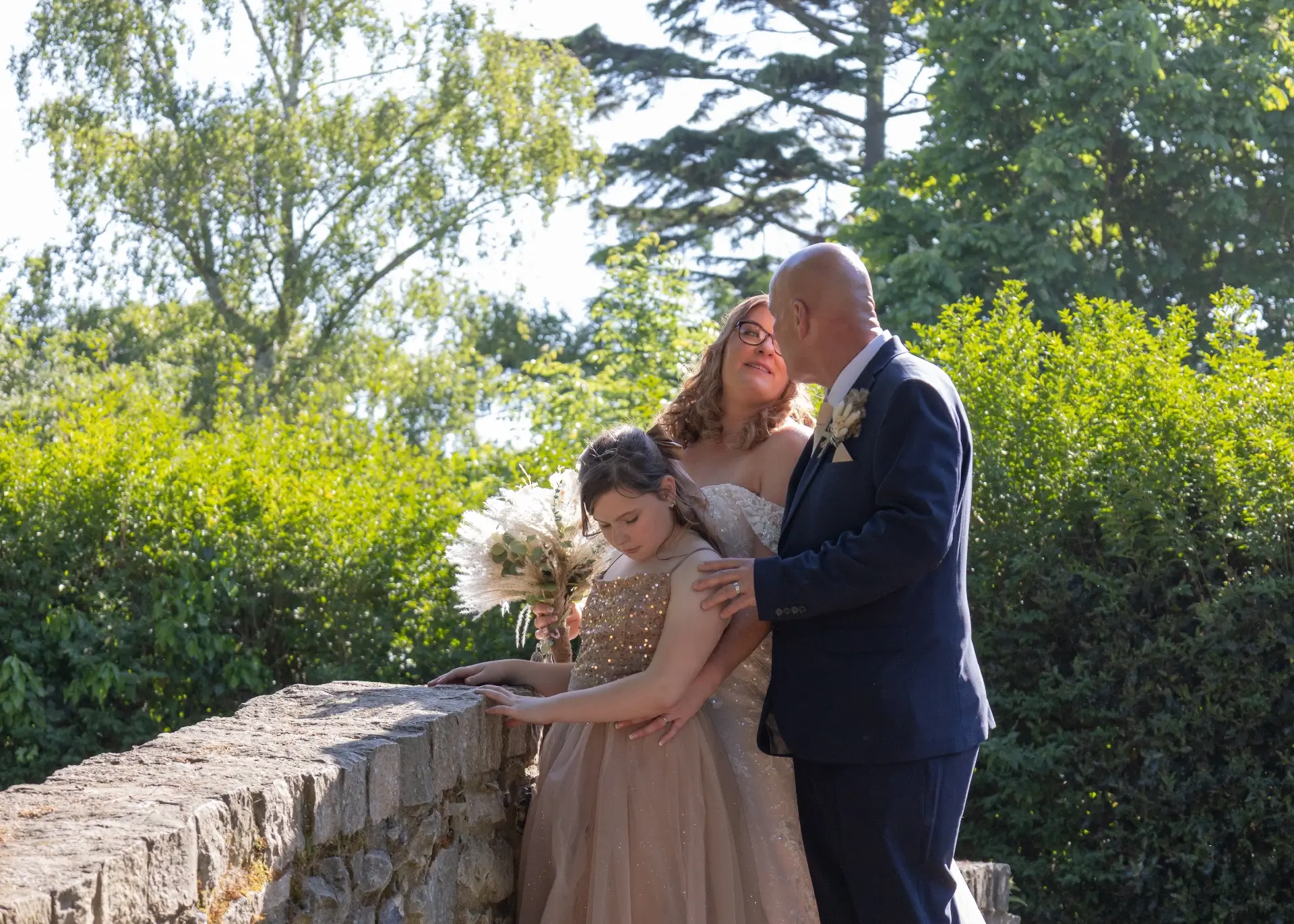 Bride and groom enjoy the grounds at Langtons House with their daughter