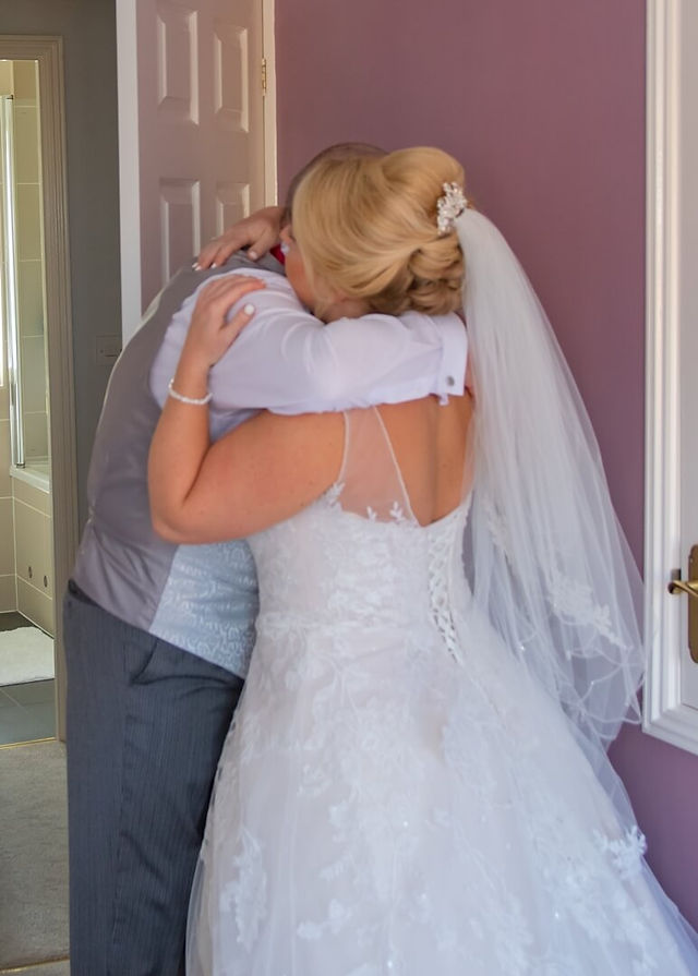 Emotional dad hugs his daughter before they leave for the church