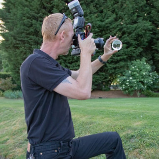 Wedding photographer taking a photo using a crystal ball for a different effect