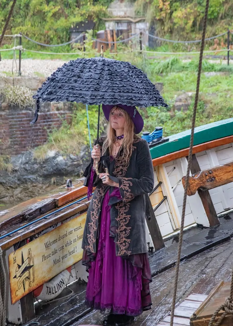 Pirate handfasting in the rain with perfectly matched umbrellas