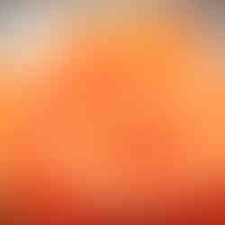 String of pearls resting on a bouquet of orange roses