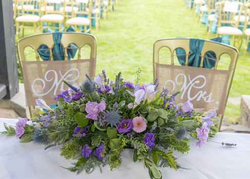 Outdoor wedding ceremony set up with Scottish themed decorations at Prested Hall in Essex