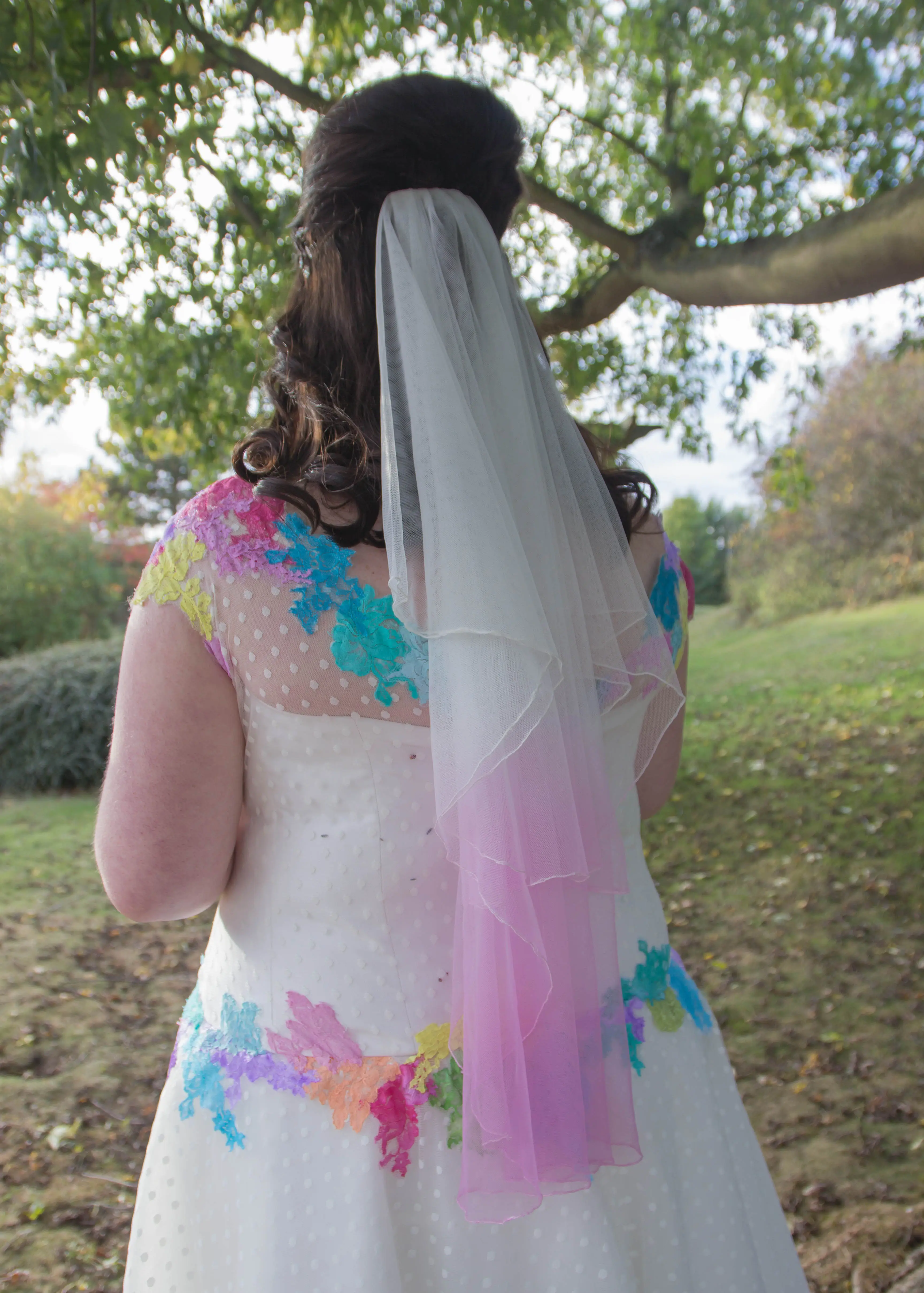 Bride shows off her dipped wedding veil to match her dress