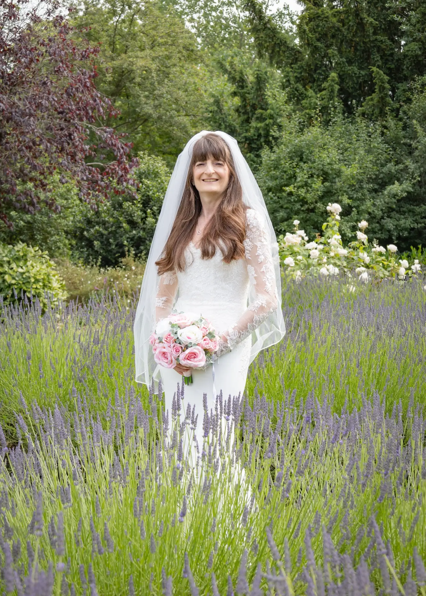 Bride surrounded by lavendar in the grounds of Lngtons House