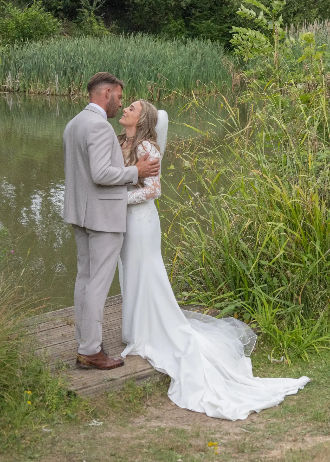 Relaxed and romantic wedding photo by the lake at Newland Hall