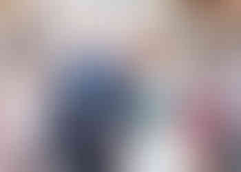 Bride and groom laugh as they walk through conetti thrown by wedding guests at Langtons House