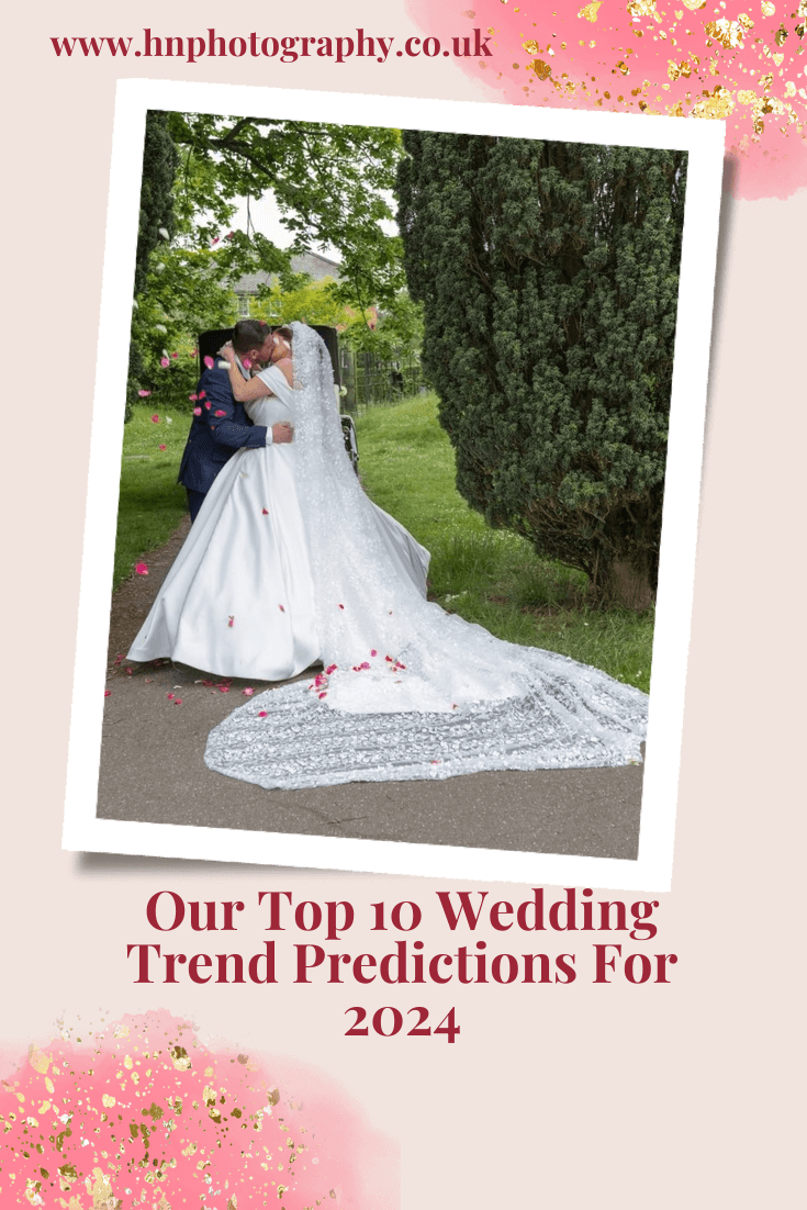 Bride with long crystal encrusted veil kissing in front of greenery
