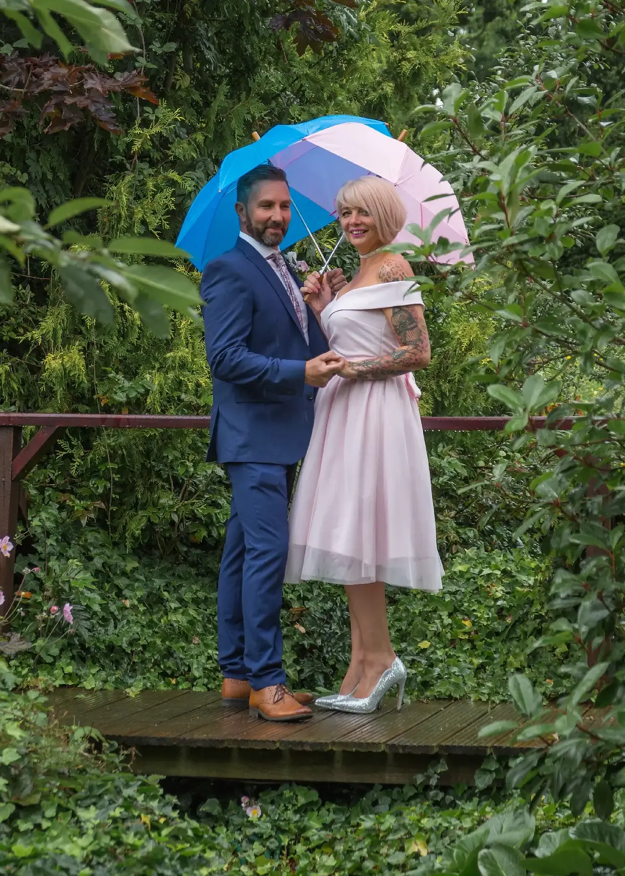 Bride and groom on the bridge in the rain at The Ivy Hill Hotel