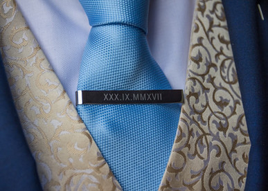 Grooms tie clip engraved with the wedding date in Roman numerals