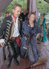 Pirate couple jump the broom at the end of the ceremony