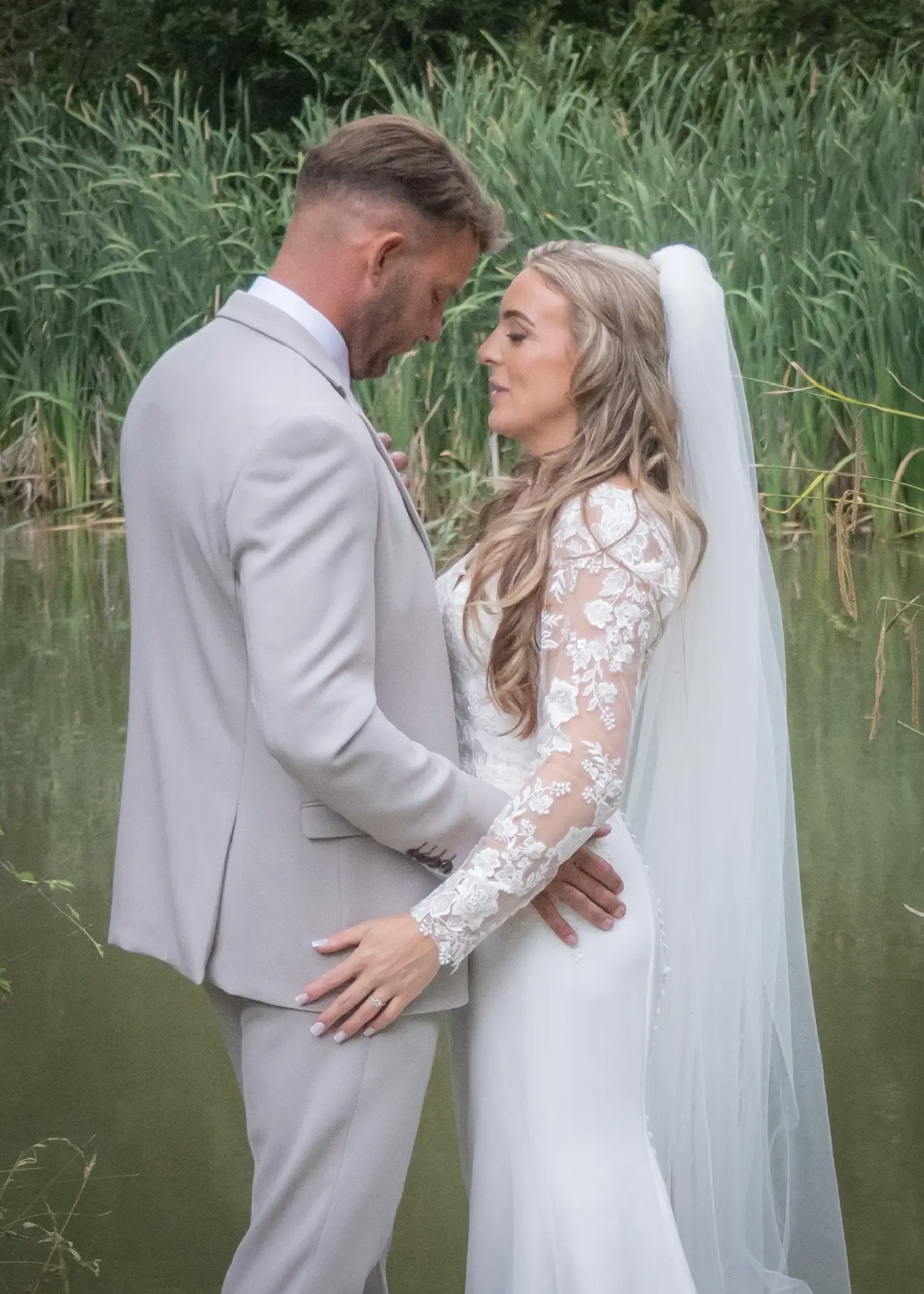 Bride and groom portrait by the lake at Newland Hall