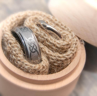 wedding rings in hessian inside round wooden ring box