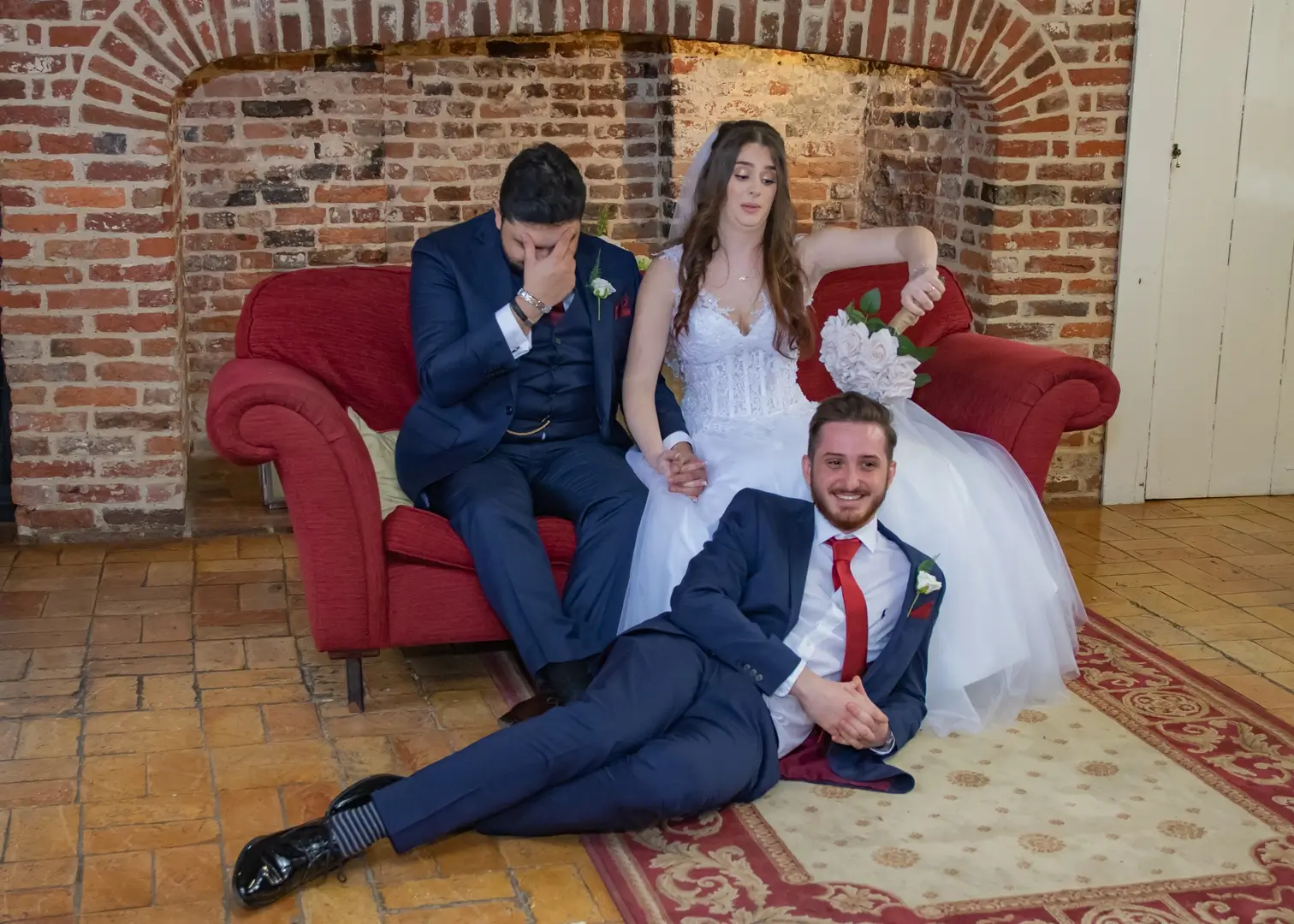 Best man relaxes for a photo with the bride and groom at Leez Priory