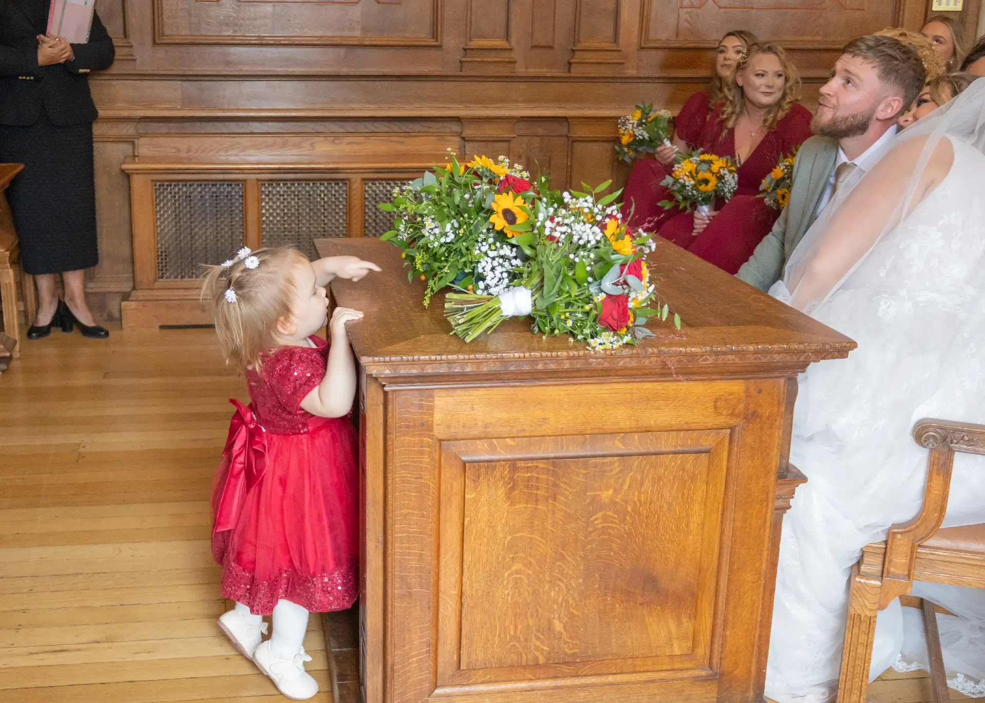 Young wedding guest playing hide and seek at Braintree Town Hall