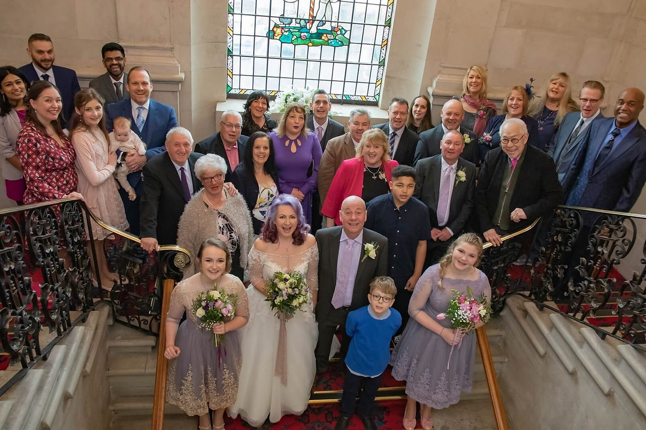 Full wedding party on the stairs at Braintree Town Hall