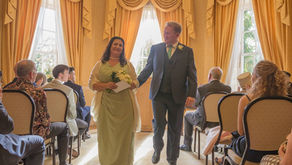Bride in mint dress and groom leave the gold room after their wedding ceremony at Langtons House