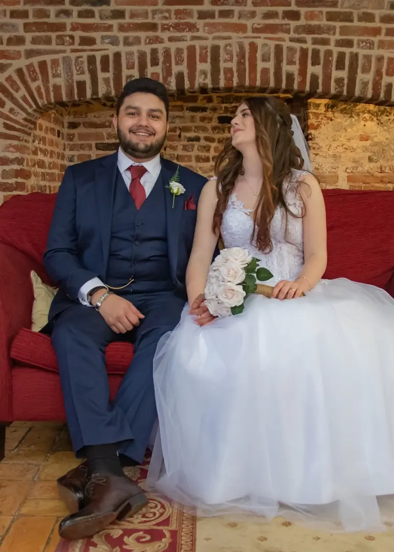 Bride and groom portrait by the fireplace at Leez Priory