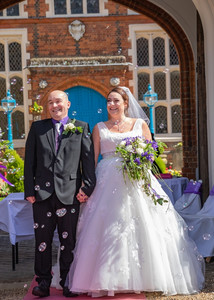 Bride and groom laughing surrounded by bubbles at Gosfield Hall