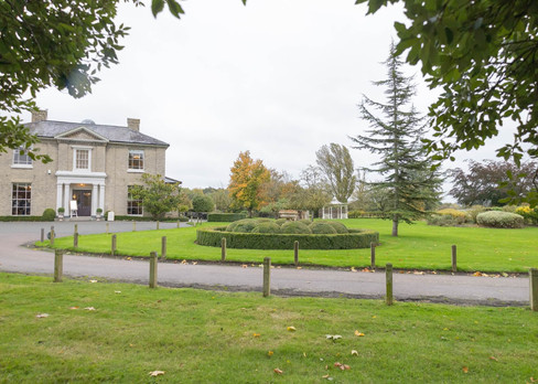 Looking at the main house from across the driveway at The Fennes Estate Essex Wedding Venue