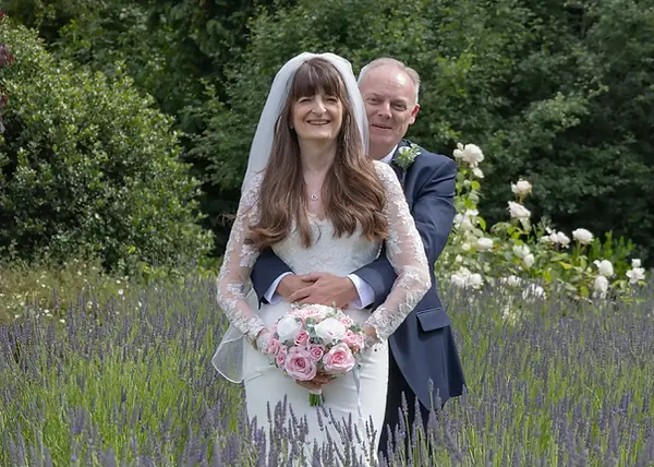Bride and groom surrounded by lavendar at Langtons House