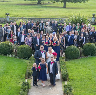 Full wedding party in the grounds of Parklands, Quendon Hall