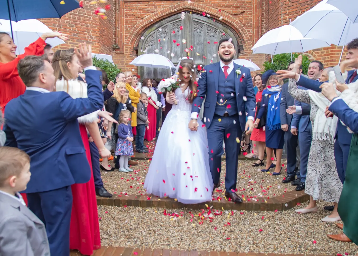 Wedding confetti in the rain at Leez Priory