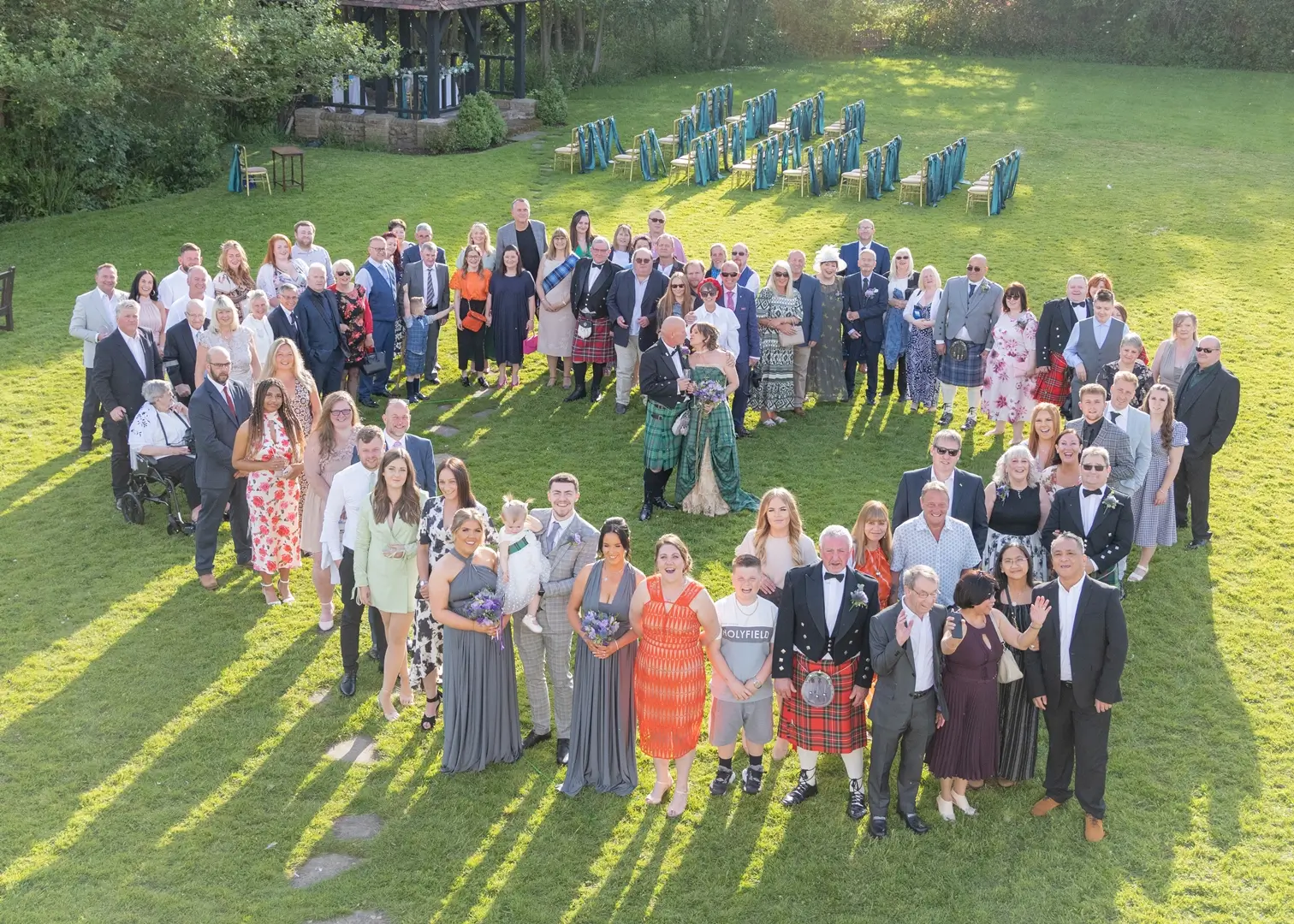 Full wedding party in the spring sunshine at Prested Hall