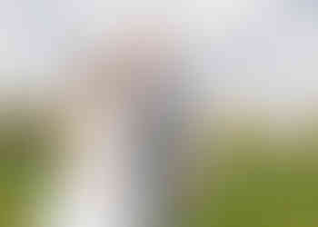 Bride and groom enjoying the sunshine in the fields beside St Catherines church, Gosfield