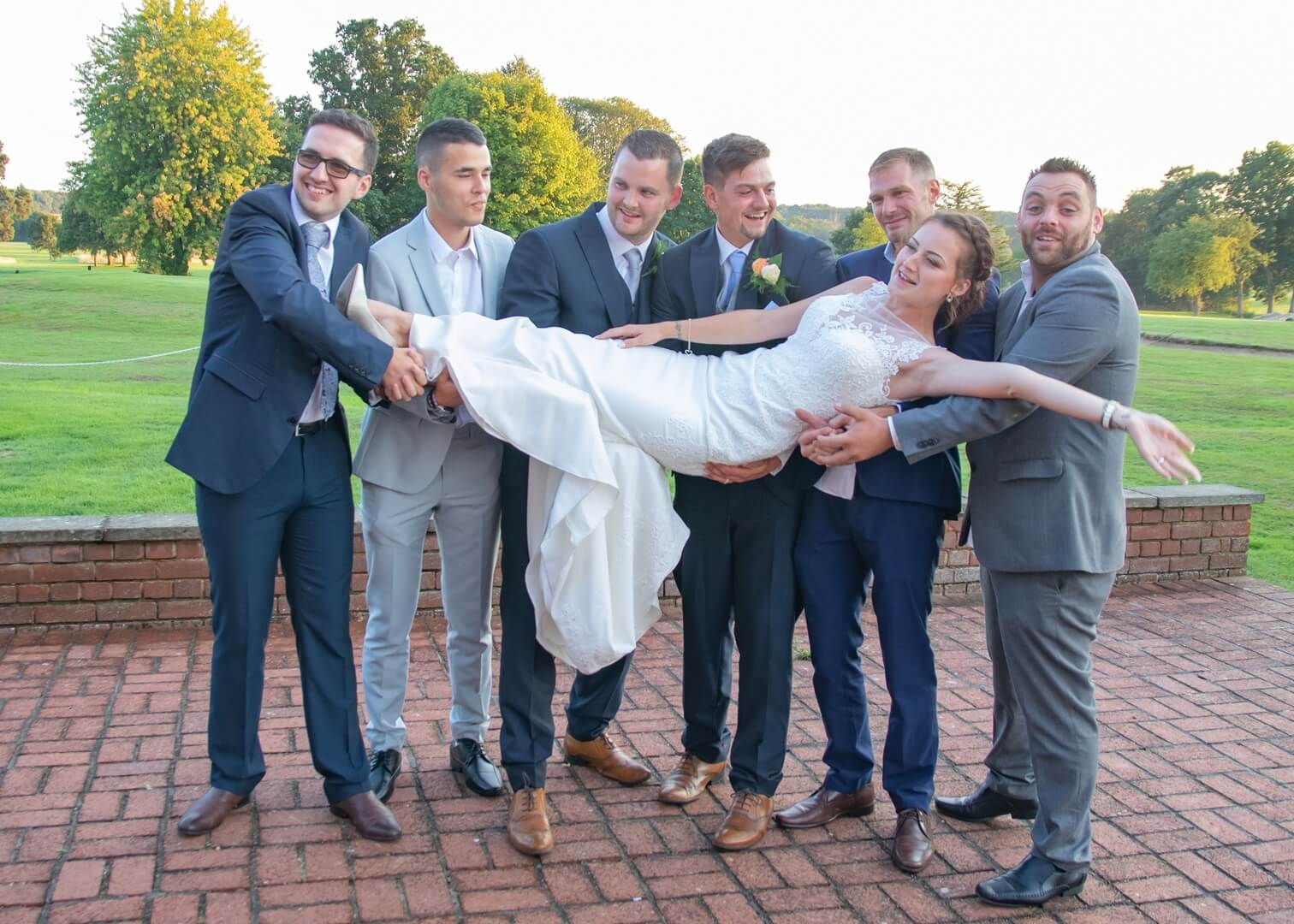 Bride is lifted by the groomsmen at Gosfield Lake Golf Club