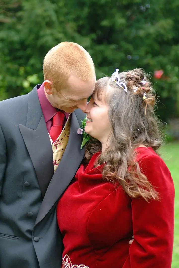 Bride in burgundy celtic medieval inspired wedding dress with her groom in matching colours
