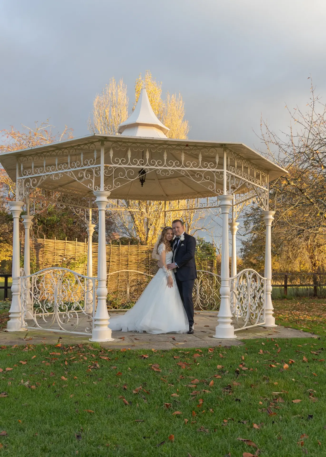 Bride and groom under the gazebo in the sunshine at The Fennes
