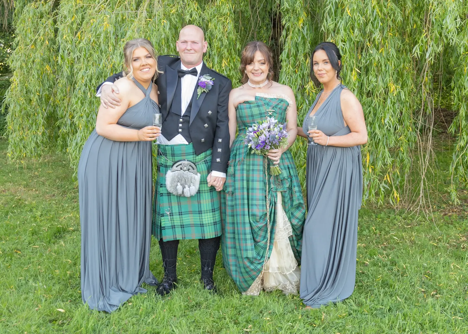 Bride and groom with bridesmaids at Prested Hall