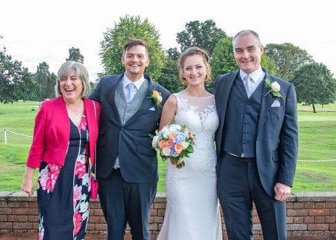 Bride and groom with brides parents at Gosfield Lake Golf Club in Essex