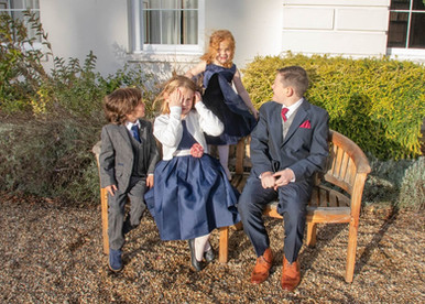 Young wedding guests enjoying the golden sunlight at Gosfield Hall
