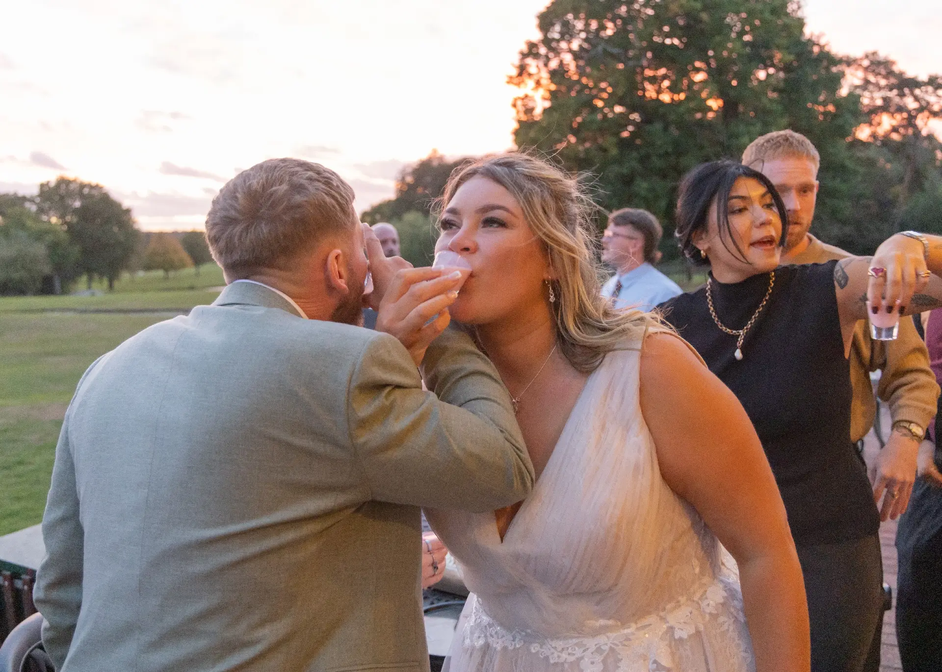Bride and groom doing shots at their wedding reception at Gosfield Lake Golf Club