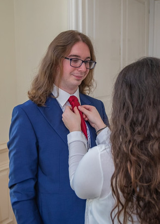 Best woman helps the groom with his tie at Gosfield Hall