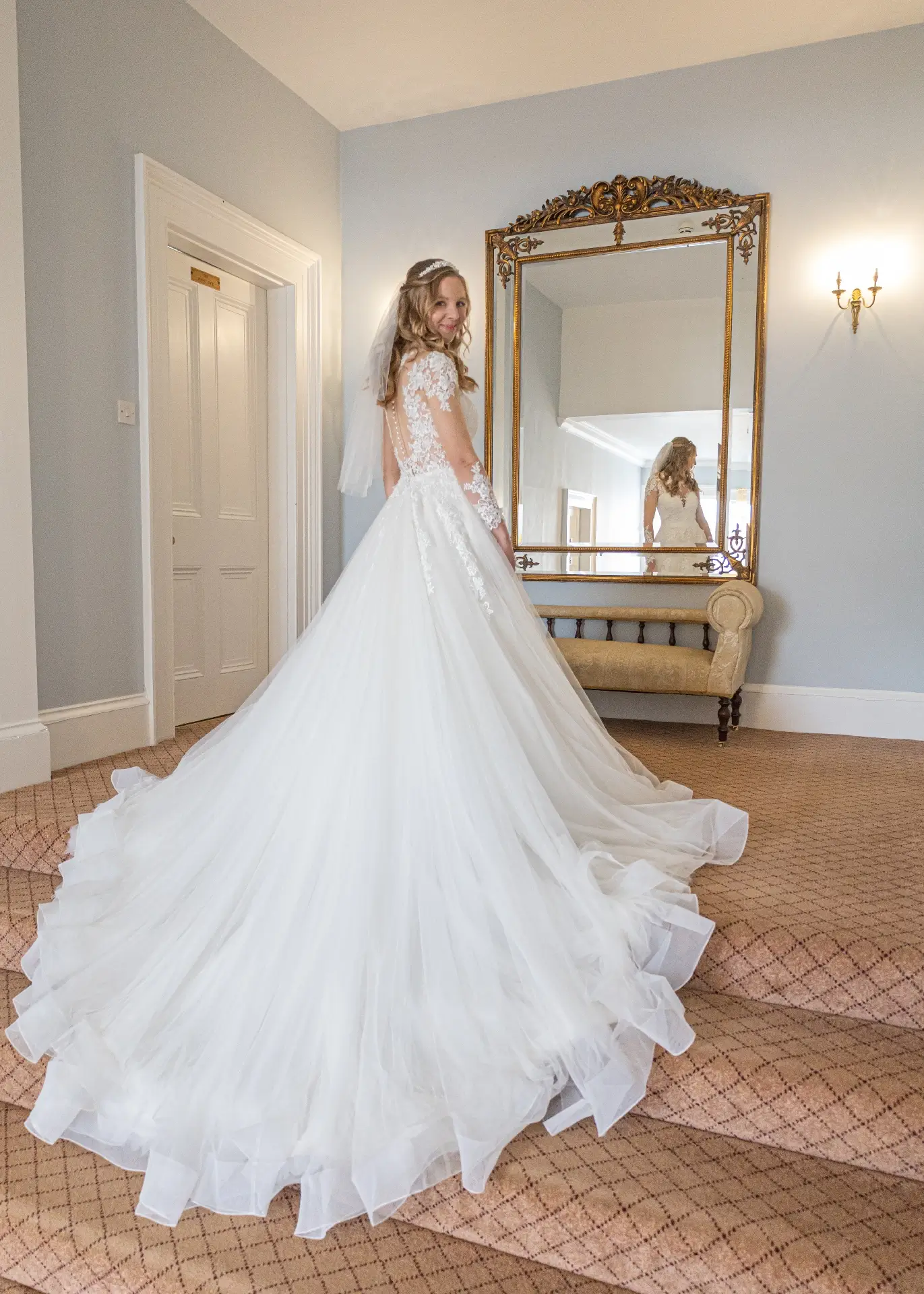 Bride at the top of the staircase at The Fennes