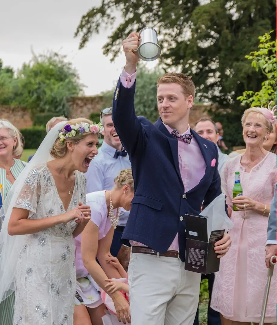 Bride laughs at the gify her groom received from her parents
