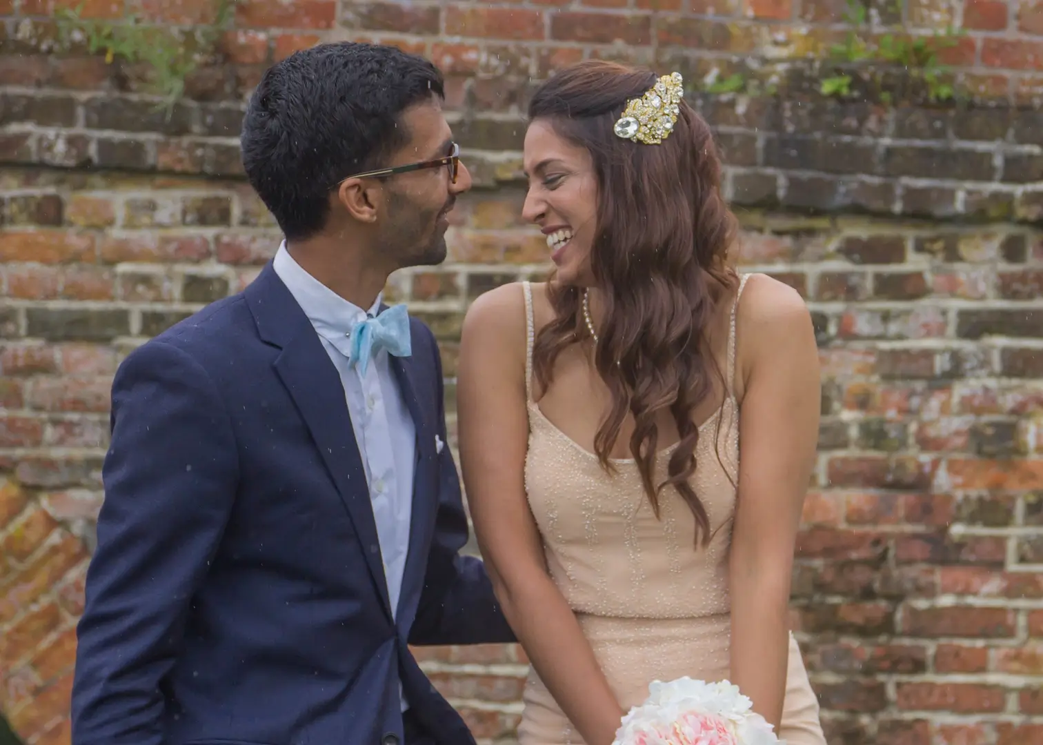 Bride and groom in a relxaed moment between rain showers