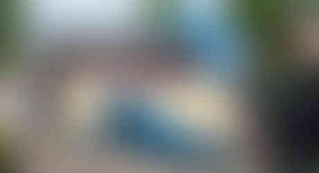 Bride, groom and wedding guests with vintage coach and bagpiper