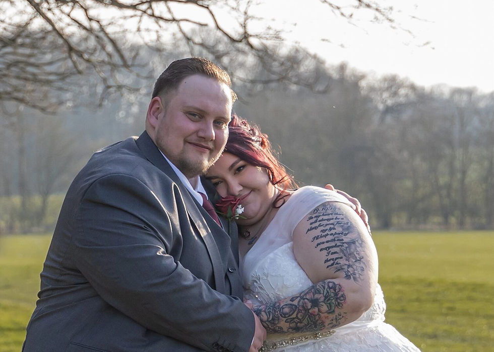 Bride and groom cuddle in the evening sunshine at Forrester Park Golf Club in Essex