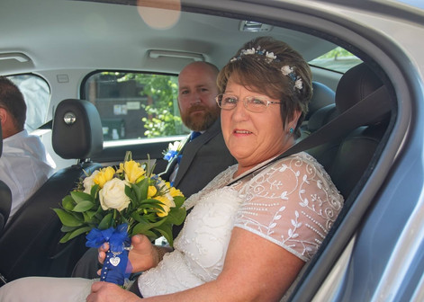 Bride in her wedding car with her son arriving at Braintree Town Hall
