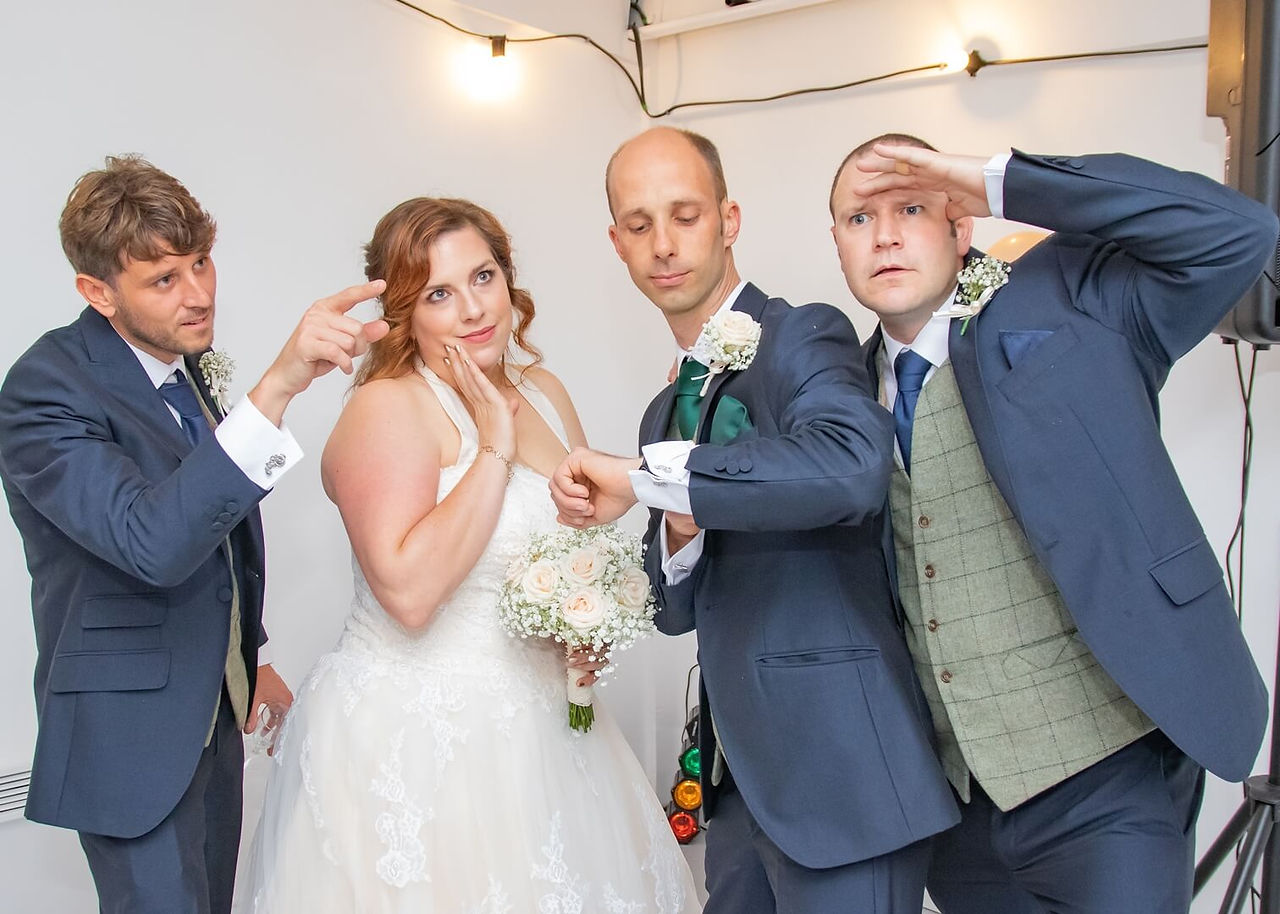 Bride, groom and groomsmen having fun