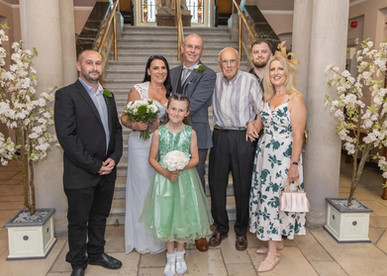 Bride and groom with his family for a portrait at Colchester Town Hall