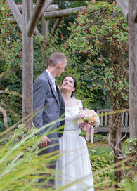 Bride and groom gaze at each other in Bocking Public Gardens in Essex