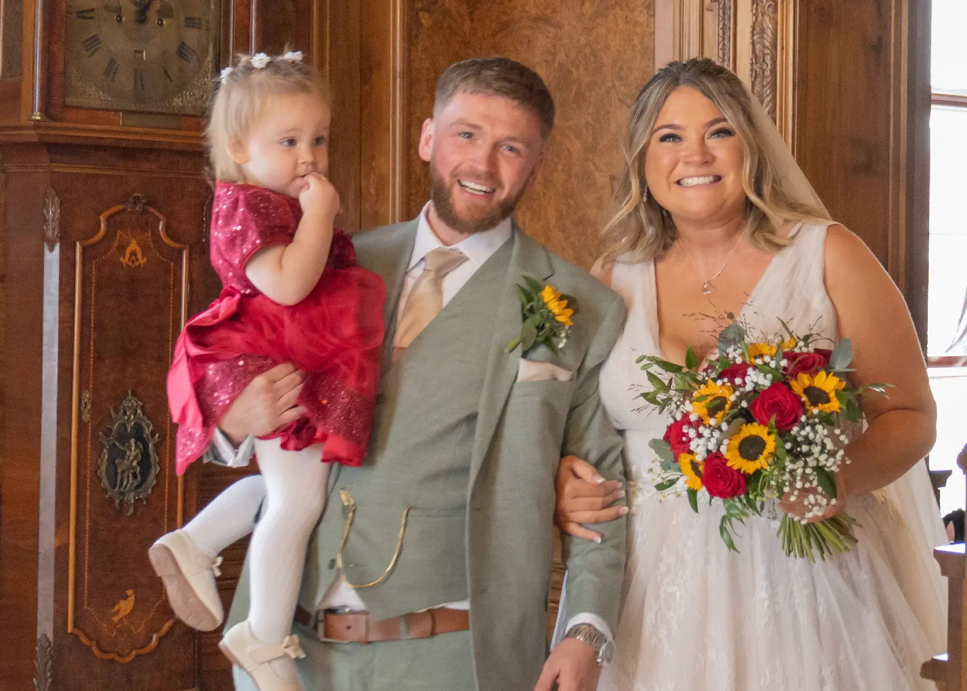 Bride and groom leave their wedding ceremony with their daughter at Braintree Town Hall