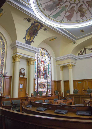 Stained glass window and corinthian columns in the council chamber at Colchester Town Hall