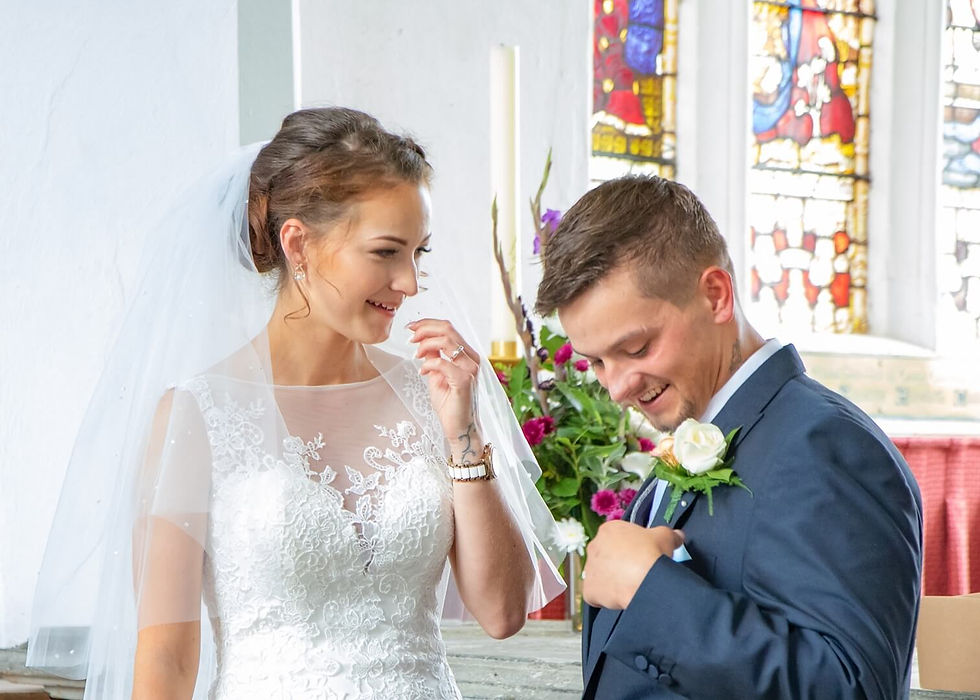Groom shows off his cardboard replacement pocket square to his bride