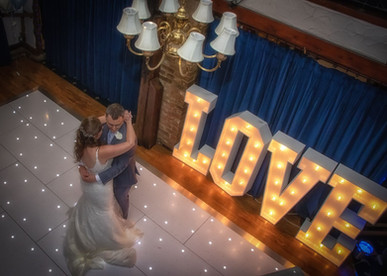 Bride and groom first dance taken from above with light up love letters