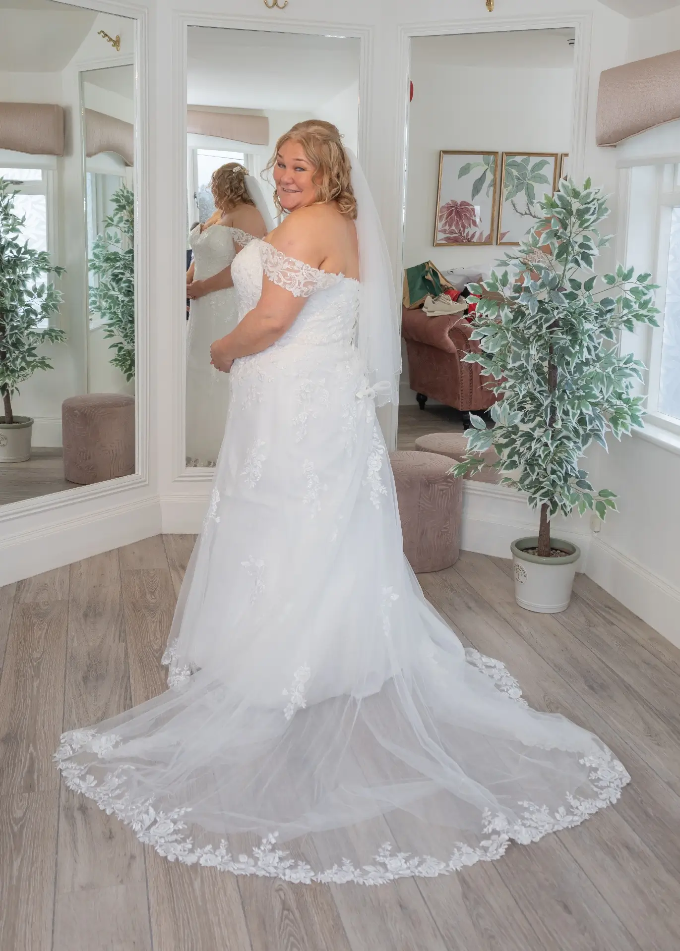 Bride smiles at the camera in the bridal suite at The Fennes